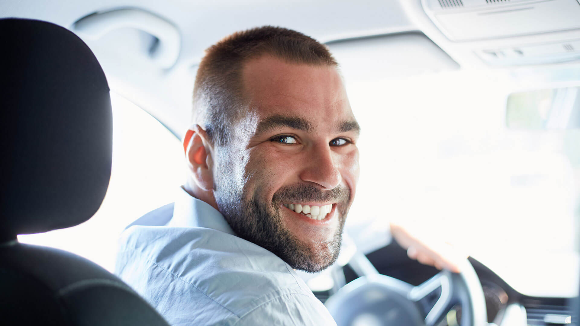 smiling guy in car